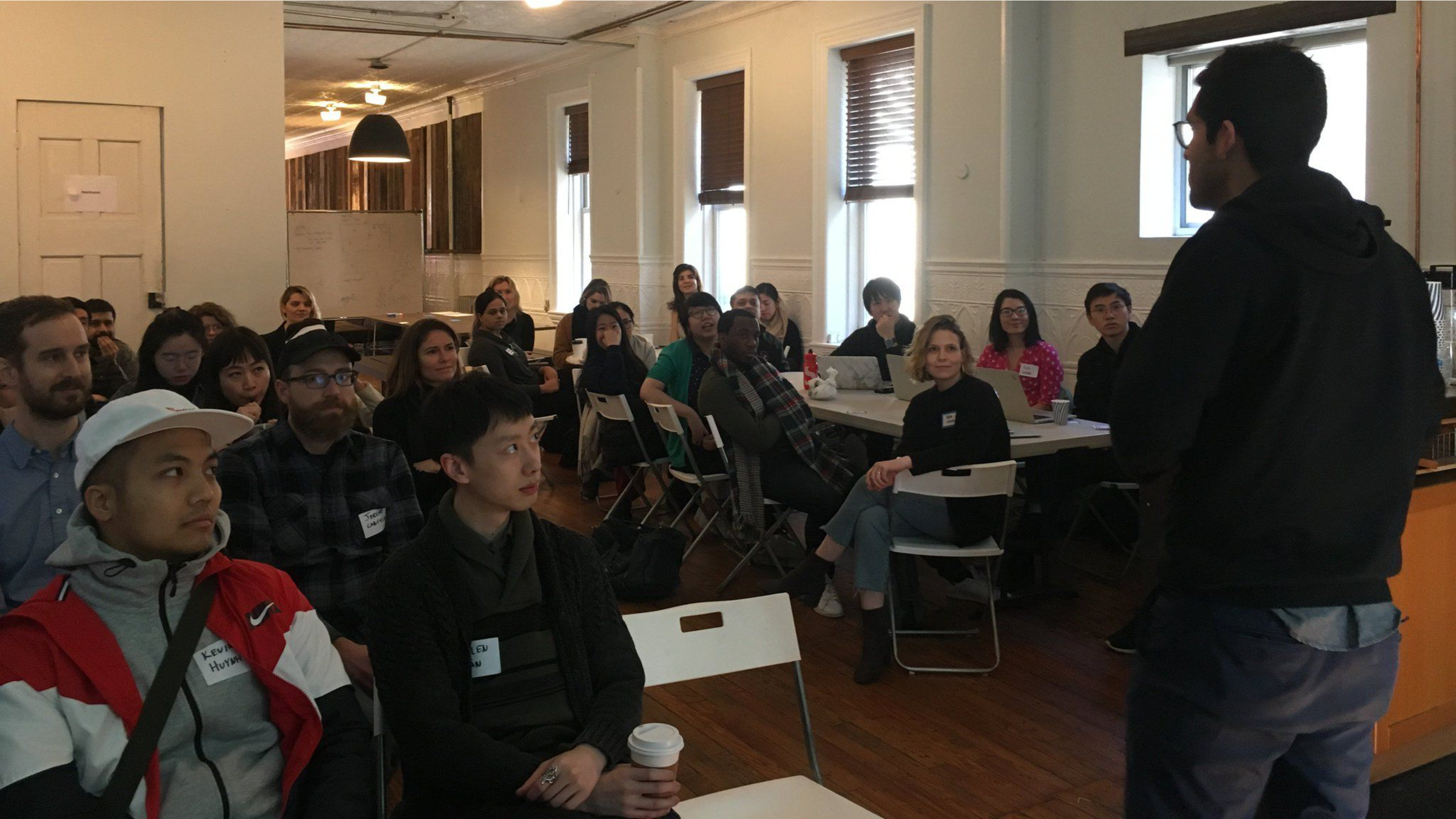  At top, students and advisors gather to listen to advisor takeaways at the end of the event. At bottom, a collage of individual meetings between students and advisors during the event.